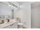 Modern bathroom featuring tiled walls, a glass block window, and a stylish vanity at 2518 Dick Wilson Dr, Sarasota, FL 34240