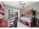 Charming bedroom featuring a wooden bunk bed and a sliding glass door leading to the pool area at 2518 Dick Wilson Dr, Sarasota, FL 34240