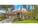 Charming single-story home with a tile roof, lush landscaping, and a two-car garage at 2518 Dick Wilson Dr, Sarasota, FL 34240