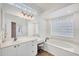 Bright primary bathroom with a soaking tub, dual sinks, and lots of natural light at 2518 Dick Wilson Dr, Sarasota, FL 34240