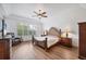 Cozy bedroom with natural light, ceiling fan, and hardwood floors, offering comfort and style at 2518 Dick Wilson Dr, Sarasota, FL 34240