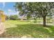 Lush green backyard with serene pond views from the home at 27427 Mistflower Dr, Wesley Chapel, FL 33544