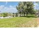 Expansive backyard with lush green grass and serene water views at 27427 Mistflower Dr, Wesley Chapel, FL 33544