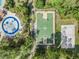Aerial view of basketball and volleyball courts with play areas, surrounded by trees and landscaping at 27427 Mistflower Dr, Wesley Chapel, FL 33544