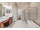Bright bathroom featuring a glass shower, soaking tub, and vanity with a sink at 27427 Mistflower Dr, Wesley Chapel, FL 33544
