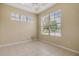 Bedroom featuring bright, natural light, tile flooring, and tray ceiling at 27427 Mistflower Dr, Wesley Chapel, FL 33544
