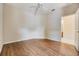 Spacious bedroom with wood floors and a ceiling fan; adjacent ensuite bath at 27427 Mistflower Dr, Wesley Chapel, FL 33544