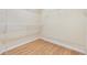 Walk-in closet with wooden floors and metal shelving for optimal storage at 27427 Mistflower Dr, Wesley Chapel, FL 33544