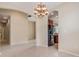 Open dining area featuring tile floors and decorative chandelier at 27427 Mistflower Dr, Wesley Chapel, FL 33544