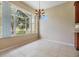 Dining room with a chandelier and a big window showing relaxing views of the lake at 27427 Mistflower Dr, Wesley Chapel, FL 33544