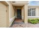 Welcoming front entrance with a brick walkway, green door, and a sidelight window at 27427 Mistflower Dr, Wesley Chapel, FL 33544