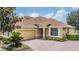 Charming home with a brick driveway, mature landscaping and a two car garage at 27427 Mistflower Dr, Wesley Chapel, FL 33544