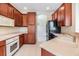 Modern kitchen features wood cabinets, white appliances, and easy-to-clean tile flooring at 27427 Mistflower Dr, Wesley Chapel, FL 33544
