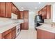 Well-equipped kitchen featuring wood cabinets, white appliances, and ample counter space at 27427 Mistflower Dr, Wesley Chapel, FL 33544