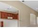 Bright kitchen featuring rich wood cabinets, white appliances, and a convenient breakfast bar at 27427 Mistflower Dr, Wesley Chapel, FL 33544