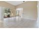 Open-concept living room with tile flooring, view to screened lanai, and tranquil water views at 27427 Mistflower Dr, Wesley Chapel, FL 33544