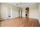 Well-lit main bedroom with laminate flooring, tray ceiling, and access to the Primary bath at 27427 Mistflower Dr, Wesley Chapel, FL 33544