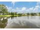 Beautiful view of community pond surrounded by manicured lawns and lovely homes at 27427 Mistflower Dr, Wesley Chapel, FL 33544