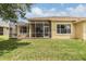 Spacious screened patio with beautiful green lawn at 27427 Mistflower Dr, Wesley Chapel, FL 33544