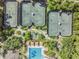 Aerial view of multiple tennis courts, a pool, and lush landscaping creating an active community space at 27427 Mistflower Dr, Wesley Chapel, FL 33544