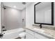 Modern bathroom featuring a tub shower combo, tiled walls, and granite countertops at 29563 Fedora Cir, Brooksville, FL 34602
