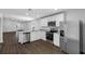 Open kitchen with stainless steel appliances, granite countertops, and hardwood floors at 29563 Fedora Cir, Brooksville, FL 34602