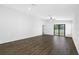 Spacious living room with hardwood floors and sliding glass doors to backyard at 29613 Fedora Cir, Brooksville, FL 34602