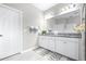 Beautifully tiled bathroom with double sinks, granite countertop, and neutral colored walls for a calming aesthetic at 30762 Parrot Reef Ct, Wesley Chapel, FL 33545