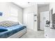 Comfortable bedroom with a soft bed, spacious closet, and gaming-themed decor for a personalized space at 30762 Parrot Reef Ct, Wesley Chapel, FL 33545