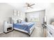 Well-lit bedroom with a comfortable bed, neutral colors, and a view of the outdoors at 30762 Parrot Reef Ct, Wesley Chapel, FL 33545