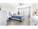 Well-lit bedroom with a comfortable bed, neutral colors, and a view of the outdoors at 30762 Parrot Reef Ct, Wesley Chapel, FL 33545