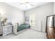 Bright bedroom with a trundle bed, ceiling fan, a large window and neutral colored decor and carpet at 30762 Parrot Reef Ct, Wesley Chapel, FL 33545