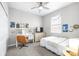 Bright bedroom featuring a desk, TV, closet and ceiling fan, decorated with posters and string lights at 30762 Parrot Reef Ct, Wesley Chapel, FL 33545