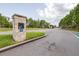 Community entrance featuring stone signage and well-maintained landscaping at 30762 Parrot Reef Ct, Wesley Chapel, FL 33545