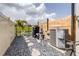 View of the home's mechanical equipment near the fence with stone landscaping at 30762 Parrot Reef Ct, Wesley Chapel, FL 33545