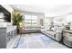 Spacious living room featuring a large sectional sofa, stylish rug, and ample natural light at 30762 Parrot Reef Ct, Wesley Chapel, FL 33545