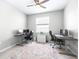 Bright office features two workstations, a ceiling fan, and neutral-toned walls and tile flooring at 30762 Parrot Reef Ct, Wesley Chapel, FL 33545