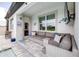 Relaxing outdoor patio area featuring comfortable seating, a TV, and stylish decor for perfect outdoor entertainment at 30762 Parrot Reef Ct, Wesley Chapel, FL 33545