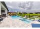 Beautiful pool and spa area with lush landscaping, offering a perfect blend of relaxation and entertainment at 30762 Parrot Reef Ct, Wesley Chapel, FL 33545