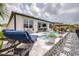 Beautiful pool and outdoor patio area with stone pavers and lounge chairs in this lovely backyard at 30762 Parrot Reef Ct, Wesley Chapel, FL 33545