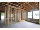 Interior view of new construction showcasing wooden framework, concrete block walls, large windows, and open layout at 3110 19Th N St, St Petersburg, FL 33713