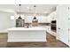 This is a modern kitchen with white cabinets, stainless steel appliances, and a large island at 3110 19Th N St, St Petersburg, FL 33713
