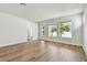 Bright living room featuring wood floors, white walls, multiple windows, and access to the backyard at 3110 19Th N St, St Petersburg, FL 33713