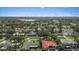 This aerial captures a home in a neighborhood featuring lush greenery, a golf course, and a serene lake at 3235 Walnut Ne St, St Petersburg, FL 33704