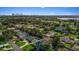 Aerial view of home within a lush, green neighborhood with scenic water views and city skyline in the distance at 3235 Walnut Ne St, St Petersburg, FL 33704