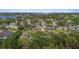 An aerial view of a residential neighborhood, featuring lush greenery and scenic water views in the distance at 3235 Walnut Ne St, St Petersburg, FL 33704
