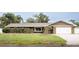 Charming single-story home featuring a brick and vinyl facade with a two-car garage and manicured landscaping at 3235 Walnut Ne St, St Petersburg, FL 33704