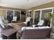 Covered patio featuring wicker furniture, a glass table, and outdoor entertainment space at 3235 Walnut Ne St, St Petersburg, FL 33704