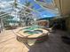 Enclosed pool area with hot tub, patio furniture, and sunny view at 3235 Walnut Ne St, St Petersburg, FL 33704