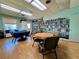 Community room with floor-to-ceiling bookshelves filled with a vast collection of books, plus several tables with chairs at 3301 Alt 19 # 819, Palm Harbor, FL 34683